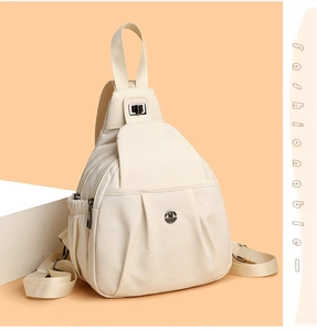 Close-up of cream PU leather backpack with pleated texture and round metal logo plate
