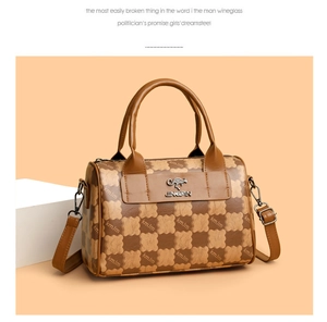 Detail of brown plaid Boston bag showing the kangaroo gold logo and leather texture