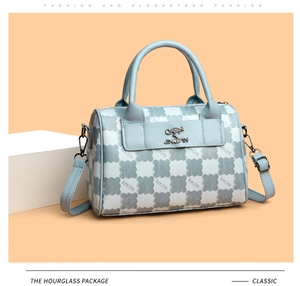 Detail of light blue cloud pattern tote bag with kangaroo logo and metallic hardware