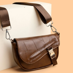 Classic brown leather saddle bag with geometric stitching and wide shoulder strap