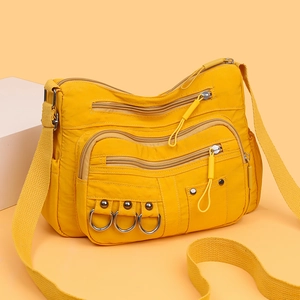 Lightweight bright yellow nylon crossbody bag with multiple zippers and wide strap
