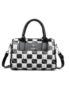 Detail of checkered tote bag showing adjustable strap and metal kangaroo logo