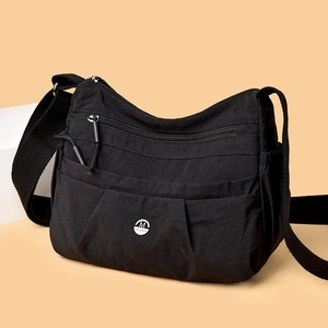 Large capacity black nylon crossbody bag with multi-layer zipper pockets and metal logo
