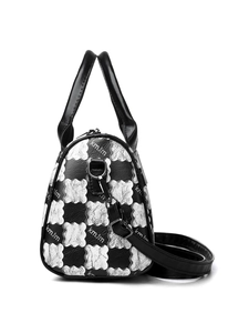 Detail view of the black and white floral pattern and logo on the Boston handbag