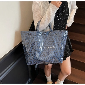 Detail of blue leopard print tote bag with glossy finish and Tote Bag lettering