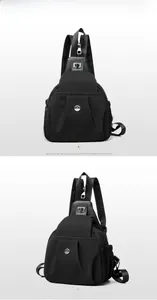 Detail of black nylon chest bag with round M logo and multiple pockets