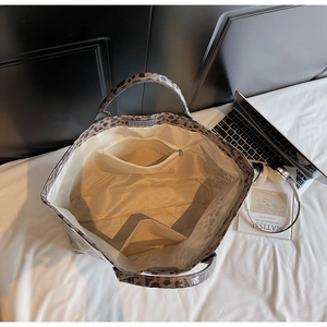 Detail view of large leopard print tote bag interior with zipper pocket and beige lining