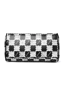 Detailed view of checkered cylinder tote bag with silver textured pattern and logo
