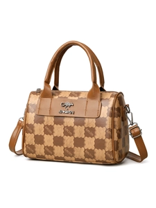 Detail of the brown Boston bag showing textured PU leather and kangaroo metal logo