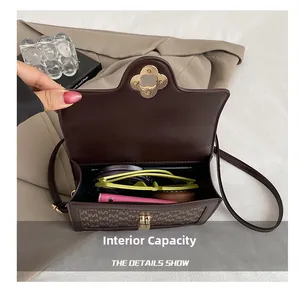 Detail view of the spacious internal capacity of the brown monogram crossbody square bag