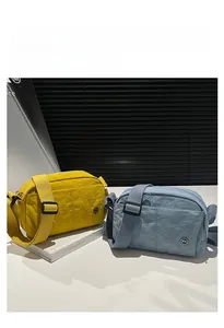 Close-up of yellow and blue quilted nylon crossbody bags with adjustable straps