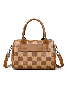 Detail of checkered floral tote bag featuring round handles and adjustable strap