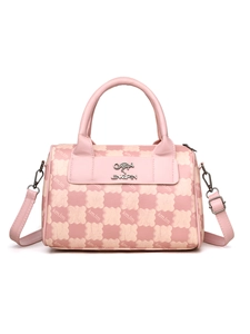 Detail view of pink and beige checkered handbag featuring metallic kangaroo logo and strap