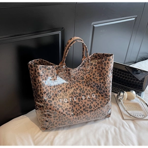 Macro detail of leopard print tote bag material and white TOTE BAG text decoration