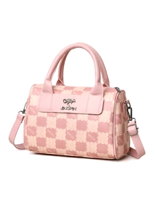 Detailed view of pink plaid Boston bag with gold kangaroo logo and adjustable strap
