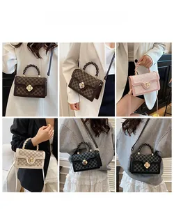 Close-up of stylish M-monogram handbags with floral metal clasps and woven handles