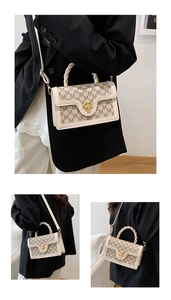 Detail of retro cream crossbody bag with M-pattern print and gold flower-shaped metal lock