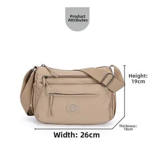 Detail view of khaki oxford crossbody bag showing dimensions 26cm width and multi-layers
