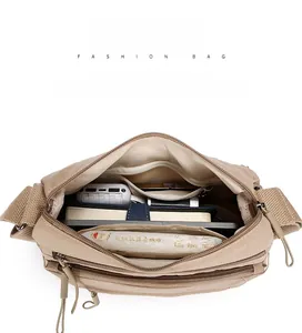 Macro view showing large capacity interior of Oxford crossbody bag with multiple pockets