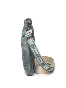 Detail view of large capacity crossbody bag with blue patterned ethnic woven strap