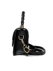 Side view of black crossbody bag featuring a woven handle and gold hardware detail