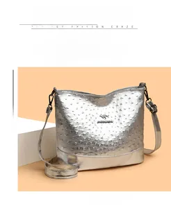Detailed view of silver ostrich textured Boston bag featuring polished kangaroo logo