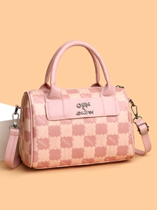 Detail of pink checkerboard Boston bag with kangaroo metal logo and pebble leather texture