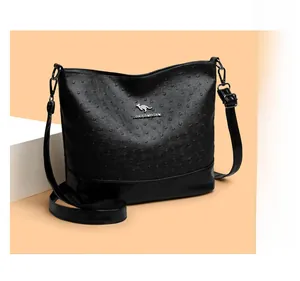 Detail of ostrich pattern leather bag with metallic kangaroo logo and adjustable strap