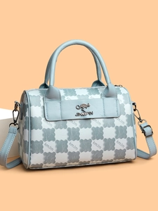 Close-up of textured leather pattern, metal kangaroo logo and silver hardware on a tote bag