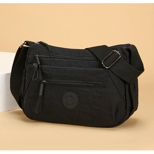 Macro detail of waterproof black nylon crossbody bag with multiple zipper pockets