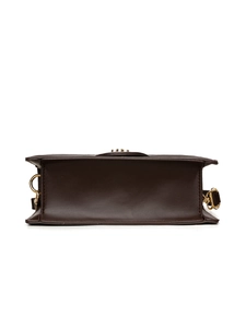 Detail view of smooth dark brown leather square bag base with gold metal hardware