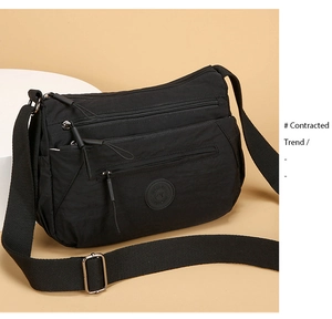 Detail of high-density black nylon crossbody bag with multi-layer zipper pockets