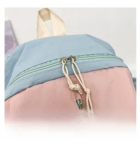 Close-up of smooth dual zippers and woven pulls on a waterproof yoga backpack