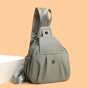 Versatile grey waterproof chest bag with multiple compartments on stylish geometric stands