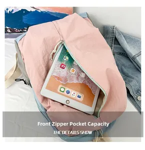 Close-up of front zipper pocket on waterproof yoga backpack holding a 10-inch tablet