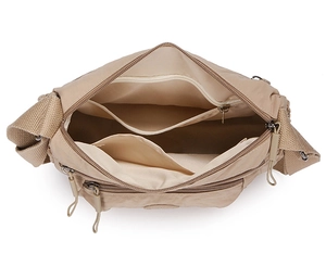 Internal view of beige nylon crossbody bag showing multiple storage compartments and pockets