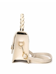 Detail of cream leather crossbody bag with woven handle and gold circular metal lock