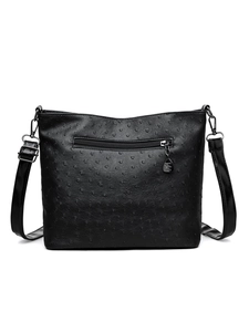 Detailed view of the ostrich texture leather back with zipper pocket on black bag