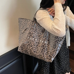 Large leopard print tote bag with waterproof clear layer and white TOTE BAG lettering