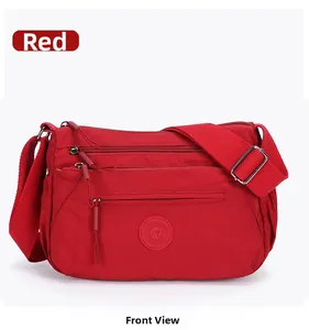 Front view of a red multi-pocket oxford cloth crossbody bag with adjustable wide straps