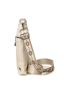 Side view of beige crossbody bag with ethnic pattern wide strap and silver hardware