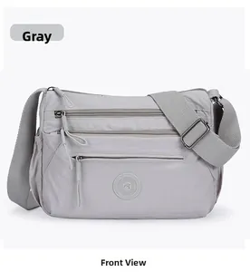Front view of a grey multi-pocket oxford crossbody bag with adjustable strap and zippers