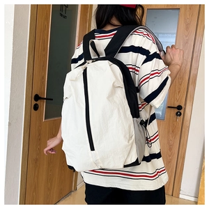 Detail of waterproof yoga backpack showing side drawstring pocket and padded bottom