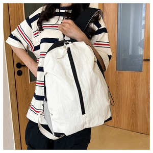 Detail of waterproof nylon yoga backpack showing black and white two-tone design and texture
