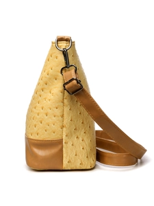 Detail of yellow ostrich texture Boston bag with brown leather contrast and metal buckle