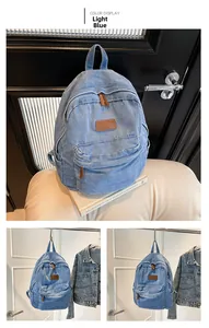 Detail view of a light blue denim backpack with front pocket and leather logo patch
