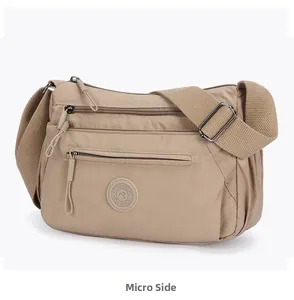 Side view of multi-pocket khaki nylon crossbody bag with adjustable strap and zippers