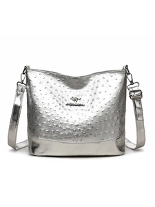 Detailed view of silver ostrich texture leather handbag with kangaroo metal emblem logo