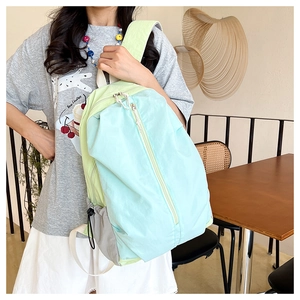 Close-up of lightweight waterproof nylon yoga backpack in blue and green patchwork