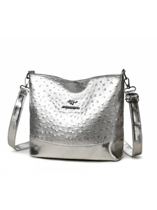 Macro shot of silver ostrich-textured faux leather and metal kangaroo brand logo